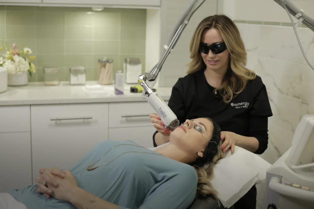 synergy aesthetician administering a laser resurfacing treatment in raleigh